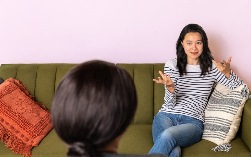 woman-sitting-in-couch-talking