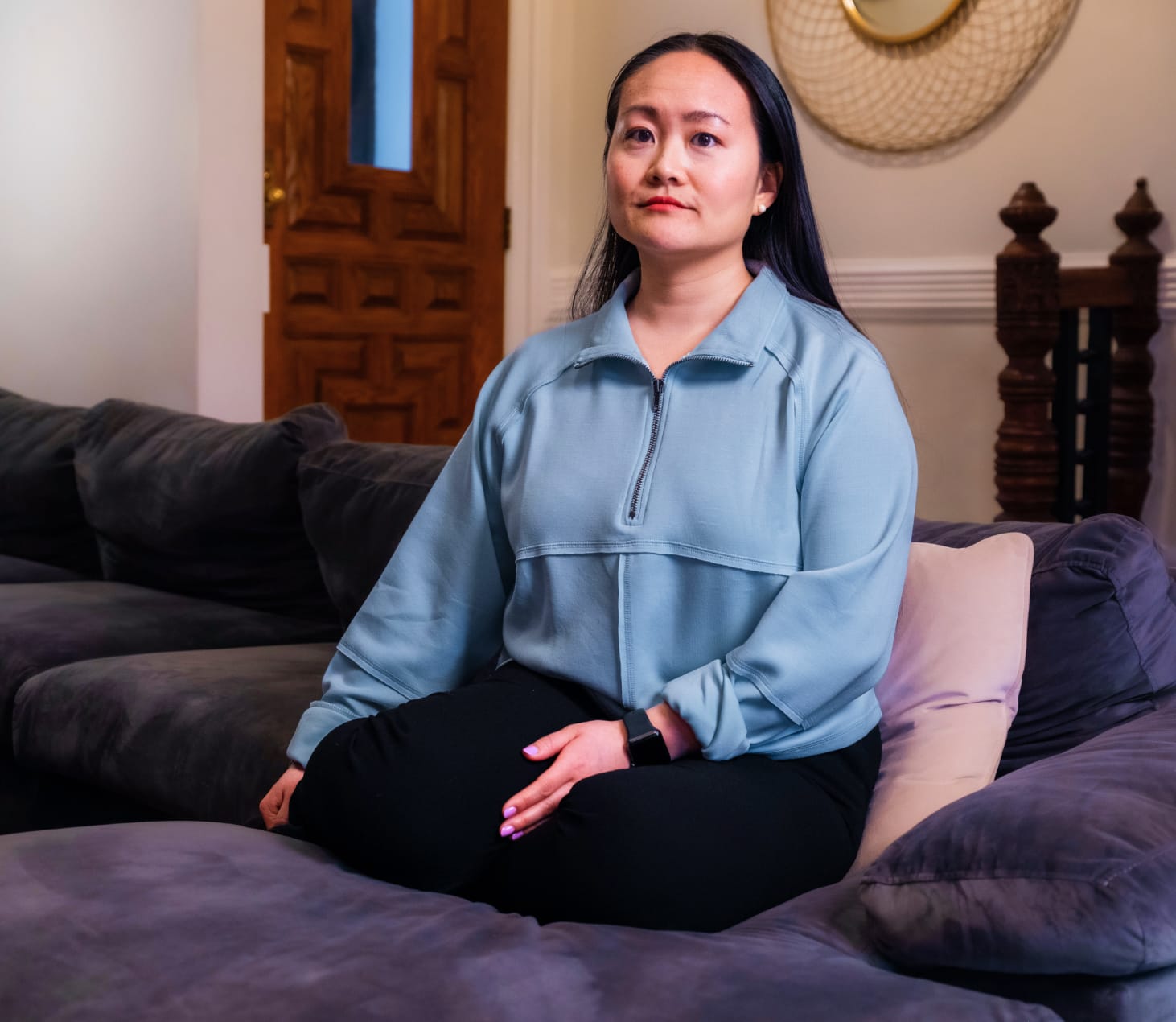 Woman sitting cross-legged on a couch