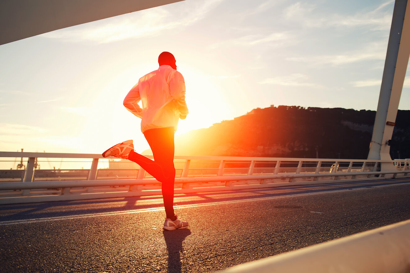 Attractive black man doing exercise at sunset