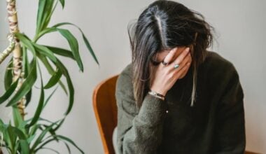 Woman in green sweater with her head down