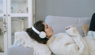 Woman lying down with headphones on