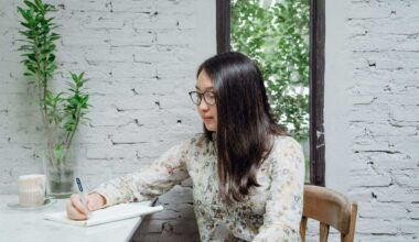 woman sitting at desk taking notes