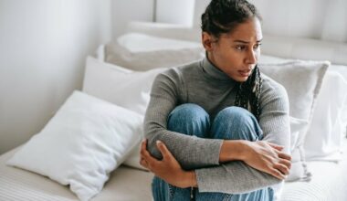 woman sitting alone hugging legs