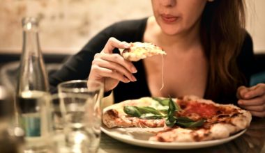 woman eating an entire pie of pizza