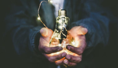 man holding lightbulb