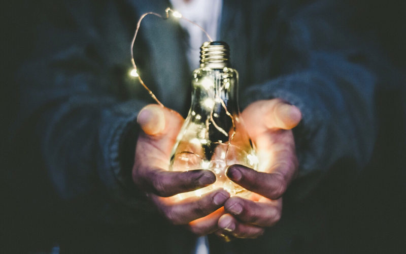 man holding lightbulb