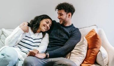 couple sitting on couch smiling