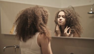 Woman looking at a mirror, body image