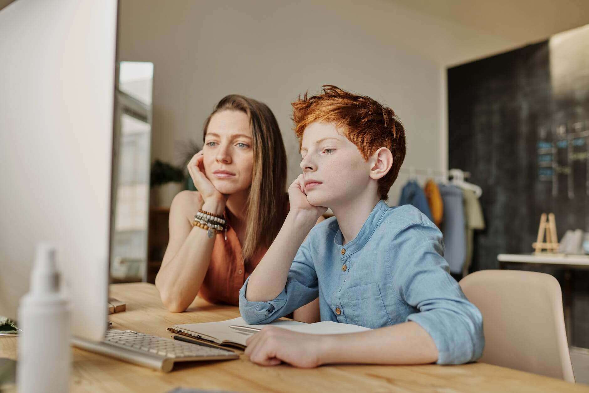 mother and son looking at computer