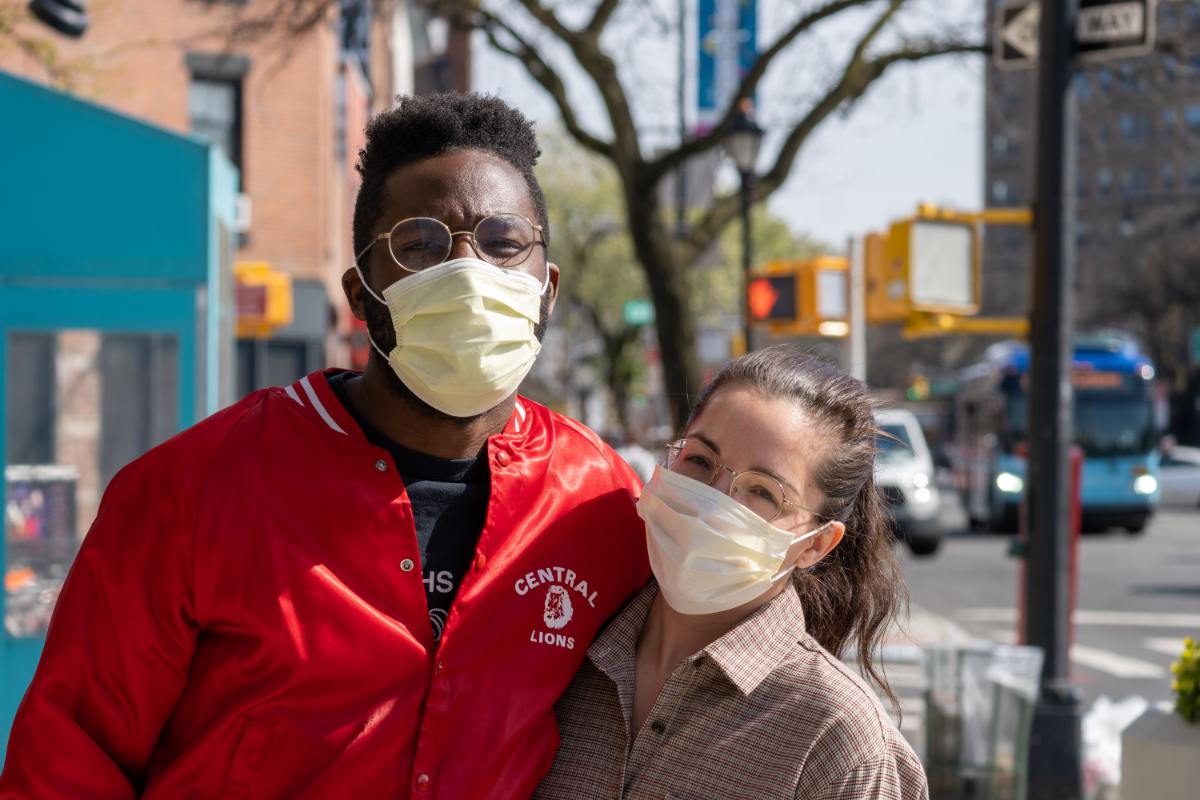 a couple of friends taking a picture together on the street