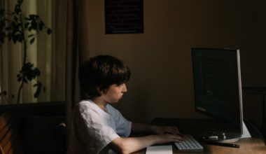 Kid staring at the computer concerned about Cyberbullying