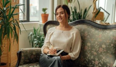 woman sitting on couch with notebook