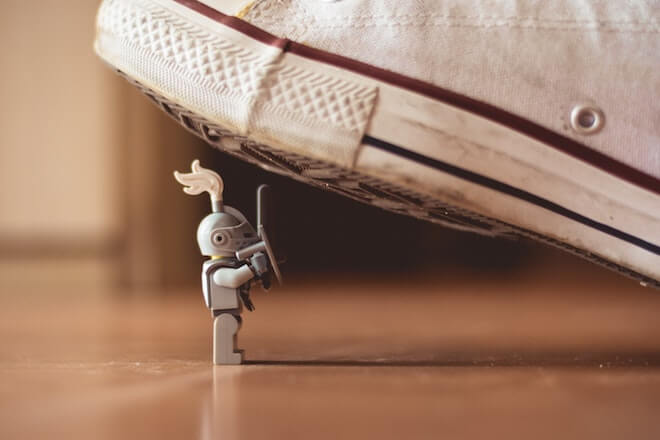 Lego knight about to be crushed under a Converse shoe