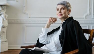 woman in black jacket sitting on chair