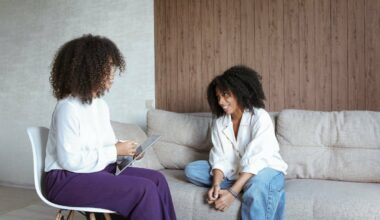 woman on chair speaking to woman on couch