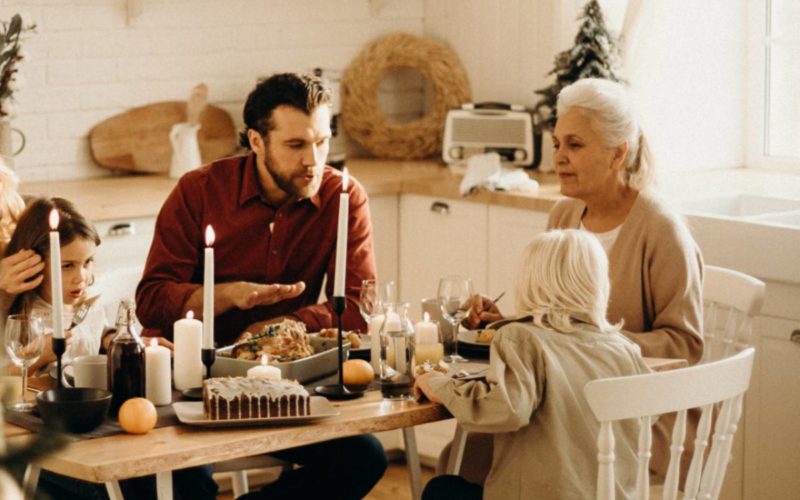 family sitting at dinner together looking slightly tense