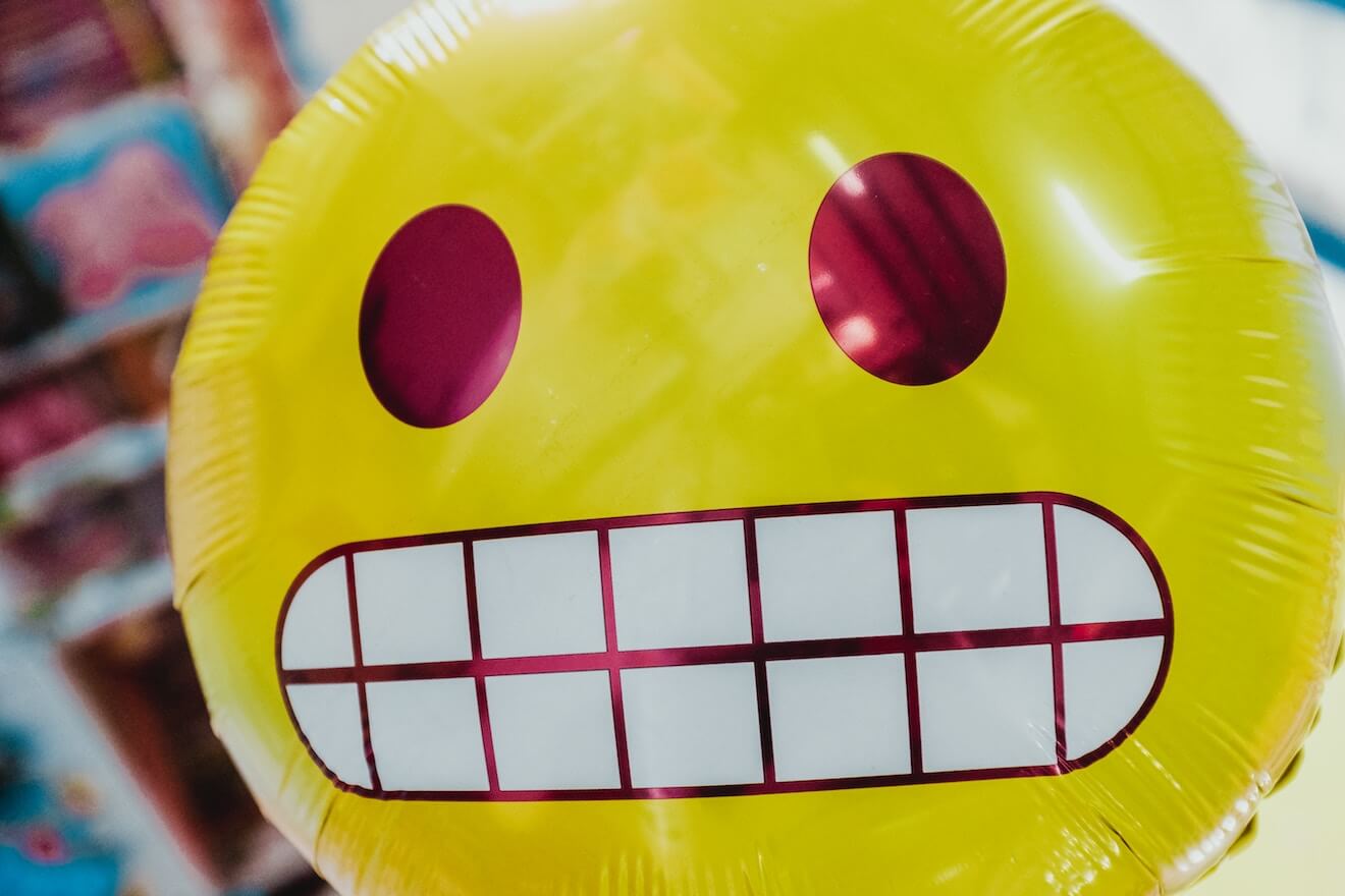 Grimacing emoji balloon