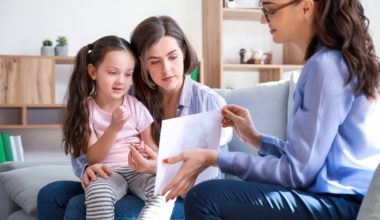 Mother holding daughter at psychologist office