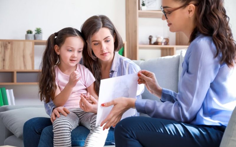 Mother holding daughter at psychologist office