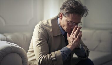 worried middle aged man sitting in living room