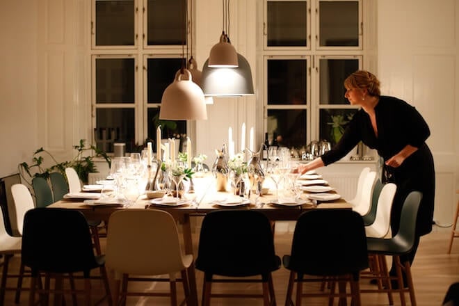 A woman sets a large table alone