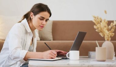 woman searching on computer and taking notes