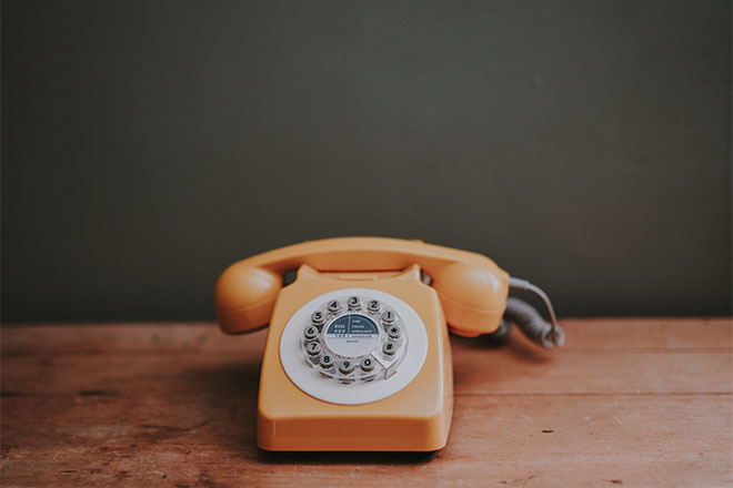 Orange telephone on a table