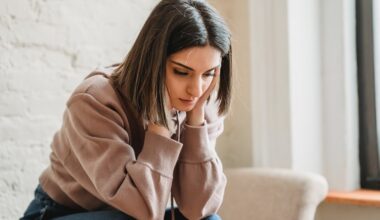 Sad young woman sitting on the couch