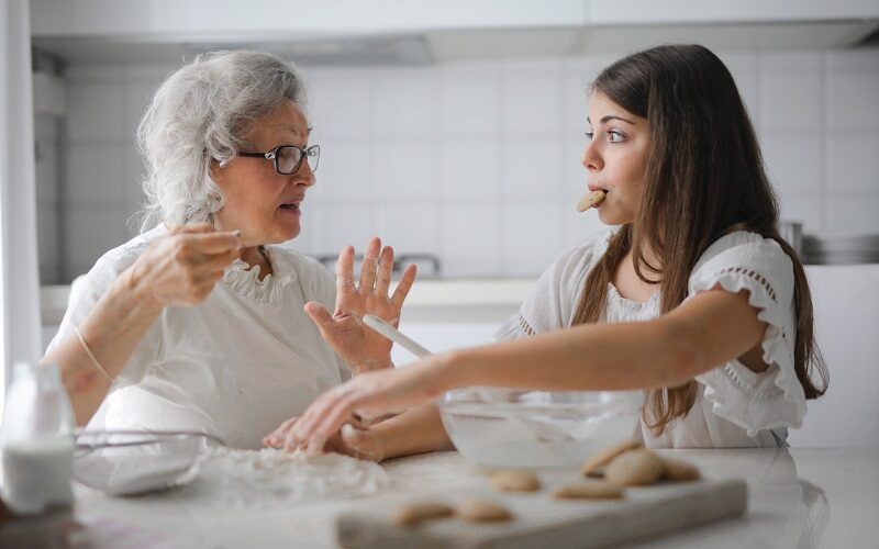 Granma and granddaughter making cookies