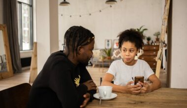 father sitting at kitchen table with daughter