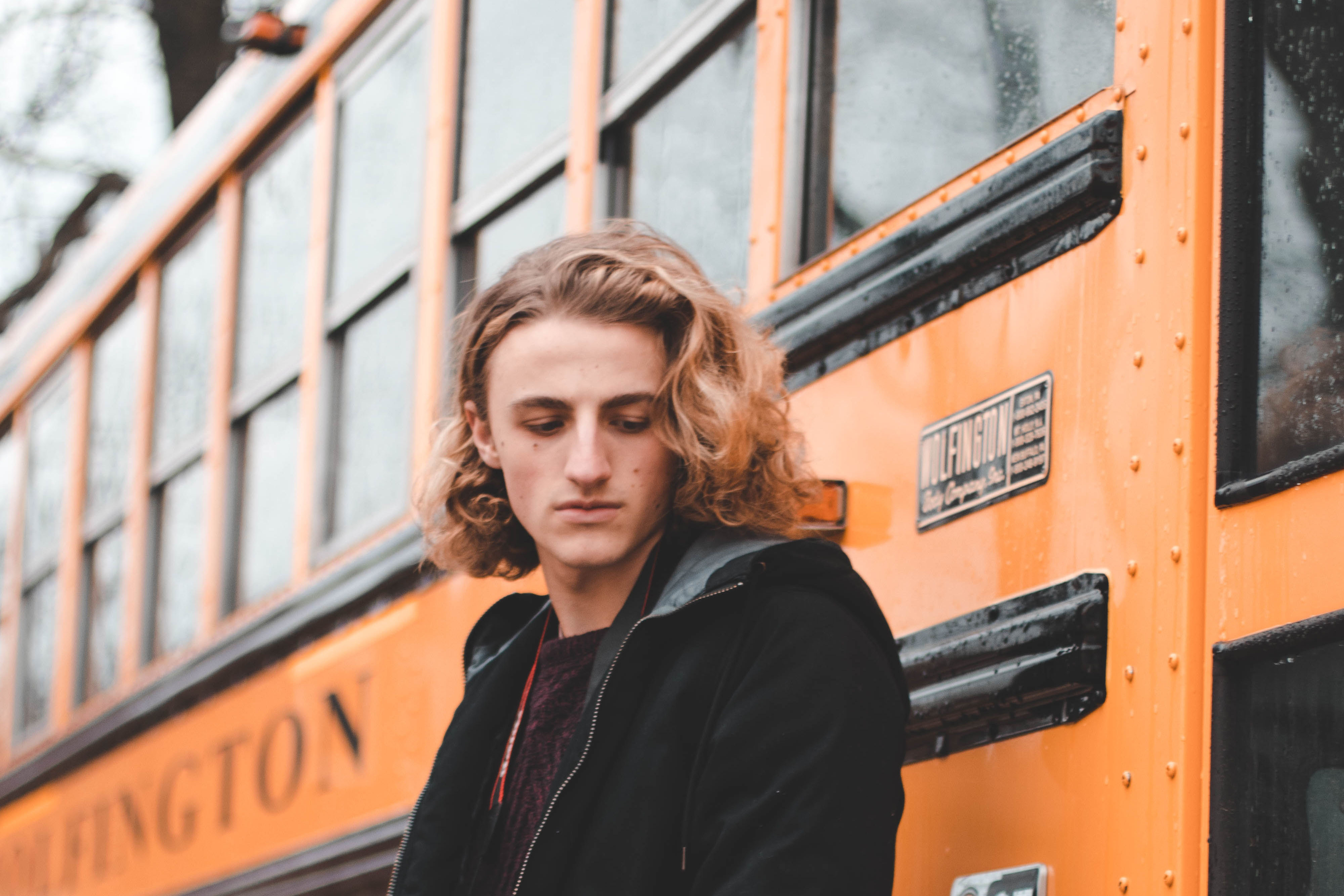 Person standing in front of school bus