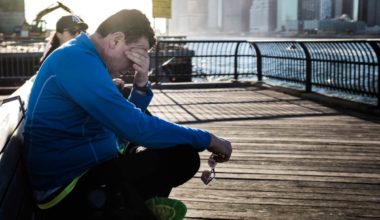 depressed man by a dock appearing to be thinking “I need help”