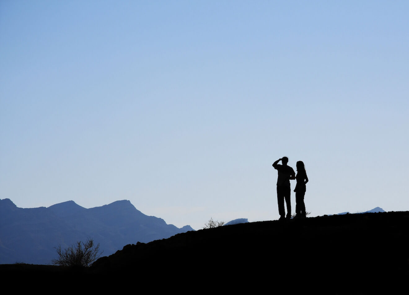 Silhouette of couple on mountain