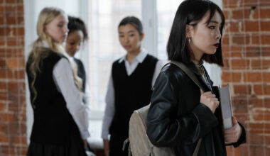 Woman in leather jacket being stared at by three classmates