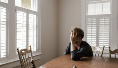 man sitting at a table looking anxious