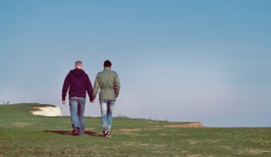 partners holding hands on a walk