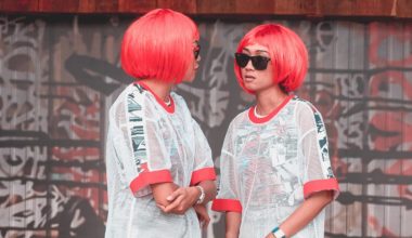 two girls in matching wigs looking at each other