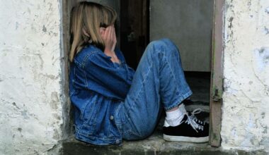 teenage girl sitting with head in hands