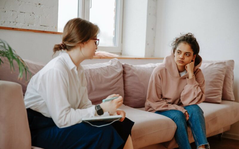 female psychiatrist speaking to client on coach