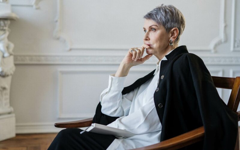 woman sitting on chair thinking