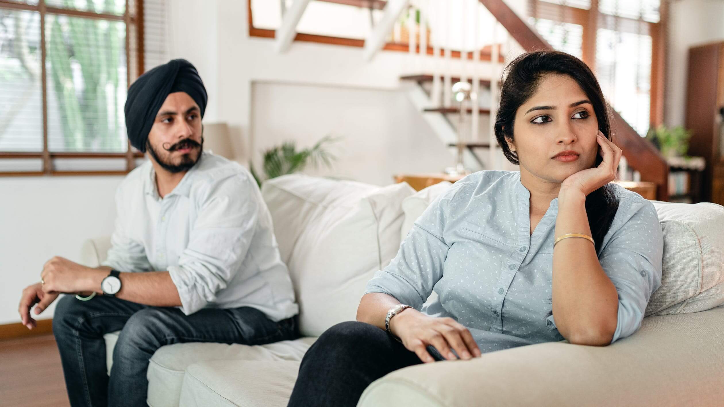 woman sitting and ignoring male partner