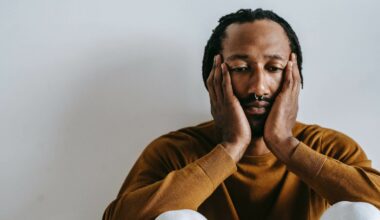 man sitting with head in hands