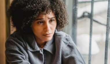 sad looking woman sitting by window