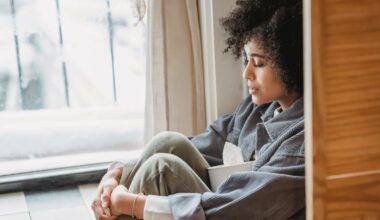 woman sitting in window looking sad