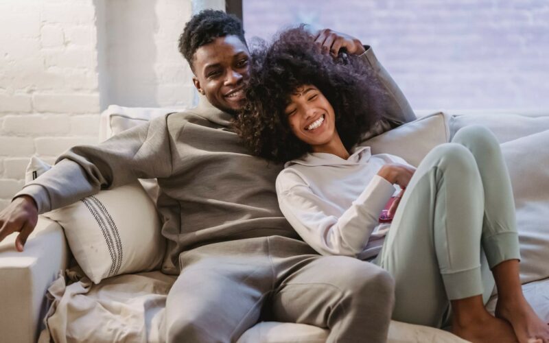 woman leaning into man on couch