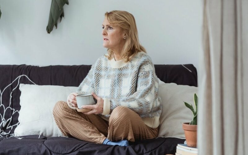 woman sitting on couch looking to side