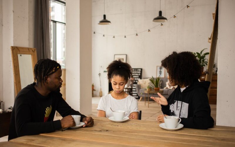 parents speaking to young daughter