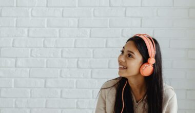 girl wearing orange headphones and smiling