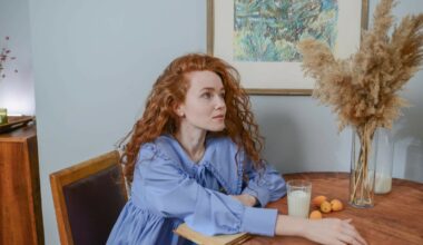 woman with red hair sitting at table