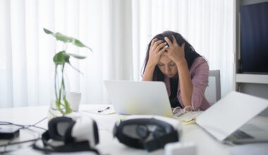 woman hunched over computer